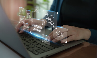 customer journey concept. typing on a laptop with illuminated icons representing e-commerce, custome