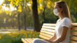 © Bonsales - Masked woman sitting solo on sunlit park bench, surrounded by verdant landscape, minimalist wide-angle perspective capturing solitary moment