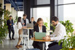 © Studio Romantic - Confident young business people working in modern office discussing work project or new startups looking at laptop screen. Company employees talking on a meeting or job conference.