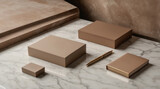 Elegant collection of neutral-toned boxes and a pen displayed on a marble surface in a modern interior setting