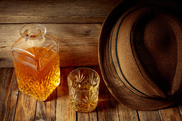 Wall Mural - Elegant whiskey glass and decanter on a old wooden table.