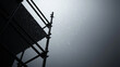 © Nakarin - Rain falls on scaffolding against dark, moody sky, creating dramatic scene