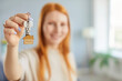 © Studio Romantic - Close-up view of a happy woman holding the keys to new home or house. She celebrates her recent purchase of real estate, excited about relocation and the beginning of a new chapter in property.