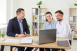 © Studio Romantic - Wife and husband engages in a discussion with a consultant during a meeting in an office, focusing on real estate or financial matters. Adviser communicating with couple of clients.