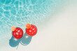 © Marina Shvedak - Refreshing summer scene with two vibrant cocktails placed at the edge of a pool, offering a cool escape on a hot day