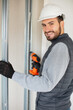 © auremar - portrait of young young worker installing doors