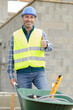 © auremar - builder carrying blocks on a wheelbarrow at the construction site