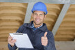 © auremar - optimistic worker builder man posing showing thumb up