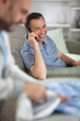 © auremar - photo of happy man lies on sofa on the phone