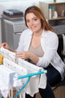 © auremar - woman hangs clean wet clots on clothes dryer