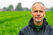 © Marut - confident farmer stands in lush green field, showcasing determination and resilience. vibrant landscape reflects his connection to nature and hard work