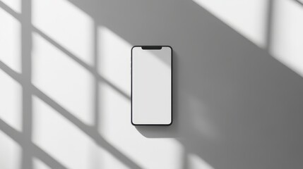Wall Mural - Blank mockup template of a slim smartphone on a plain white surface, surrounded by minimalist lighting and shadows.