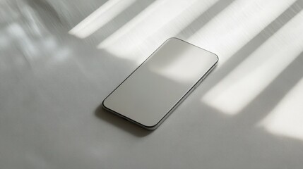 Wall Mural - Blank mockup template of a sleek smartphone on a light gray surface, with subtle shadows and a minimalistic atmosphere.
