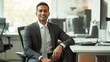 © Thavesak - Confident Indian-Canadian Businessman in Clean Modern Workspace Exudes Professionalism