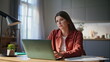 © stockbusters - Online student studying home looking laptop screen closeup. Woman working remote