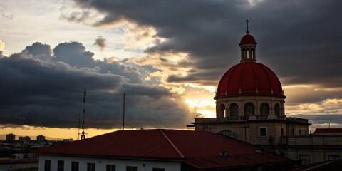 Wall Mural - Silhouette of Red Dome Building Cloudy Sky Dramatic Sunset Architecture