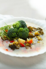 Wall Mural - Healthy vegetable soup with broccoli florets, potatoes, and carrots.