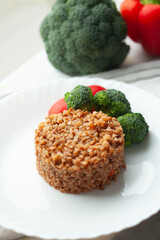 Wall Mural - Buckwheat groats with broccoli and tomatoes. A healthy and delicious meal.