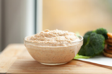 Wall Mural - Creamy dip in a glass bowl, ready to be enjoyed with fresh vegetables.