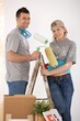 © nyul - Portrait of young couple painting their new home, smiling, standing together on ladder.