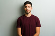 © AntonioDiaz - Young man posing with serious expression against gray wall
