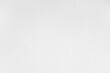 Close-up of textured white paper with a subtle grain pattern. It appears clean and smooth, ideal for artistic or writing purposes, showcasing its natural grainy surface.