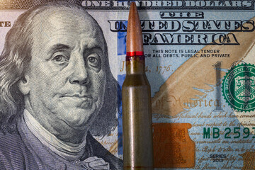 Background with American dollars and bullets from a machine gun. Global world crisis and world war