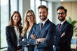 © miss irine - Confident business team poses for professional photo. Diverse group of men, women in business suits stands together. Look happy, successful. Teamwork, pro atmosphere. Modern office background.