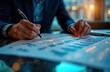 © miss irine - Businessperson examines glowing financial charts on table with digital data overlays. Person analyzes financial data on papers with illuminated details. Advanced tech used for analysis. Focus on