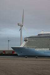 Front, bow, of a Cruise Ship with two windmills in the background, Eemshaven