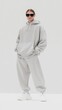© Dina - mockup of a plain gray hoodie on a woman, ideal for branding and design.