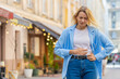 © Andrii Iemelianenko - Sick ill young blonde woman suffering from period cramps painful stomach ache outdoors. Lady girl holding belly feeling abdominal menstrual pain standing on urban city street. Abdominal pain gastritis