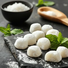 Wall Mural - A simple yet elegant dessert garnish with fresh mint leaves and white sugar on a dark background