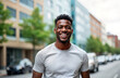 © miss irine - Happy African American man smiles at camera outdoors on city street. Man wearing casual attire. Urban setting background with buildings, cars. Positive emotion, freedom, happiness concepts. Lifestyle