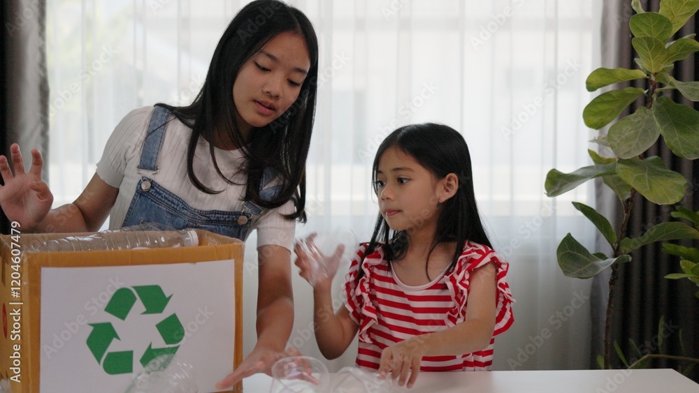 Asian little Girls dump plastic bottles in recycling boxes to reduce ...