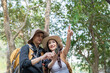 © Natee Meepian - LGBT couple using a smartphone to navigate during their hiking adventure in nature