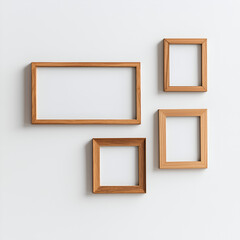 Four wooden picture frames of varying sizes arranged on a white wall, showcasing a minimalist and modern aesthetic.