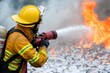 © Moopingz - A firefighter in protective gear is spraying water on a blaze, demonstrating bravery and skill in battling a fire emergency.