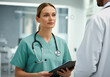 © PixelPulse Creative - A medical professional wearing light green scrubs and a stethoscope engages in a conversation with another doctor