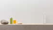 © JuanM - Minimalist display of skincare products with stones against a neutral background