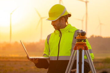 Aufkleber - Engineer working on laptop in front of wind turbines for checking wind turbines of the field during beautiful sunset. Alternative energy concept.
