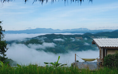 A wooden cabin in the mountains on foggy day