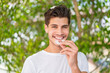 © luismolinero - Young caucasian man at outdoors holding invisible braces