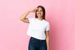 © luismolinero - Young Uruguayan woman isolated on pink background saluting with hand with happy expression