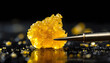 © verdian - Close-up of Golden Cannabis Concentrate with Dab Tool