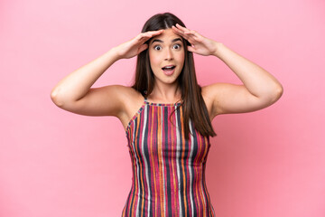 Wall Mural - Young Brazilian woman isolated on pink background with surprise expression