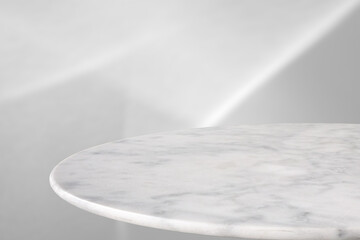 Wall Mural - Round marble table top with abstract shadow drop on white wall background for mockup product display