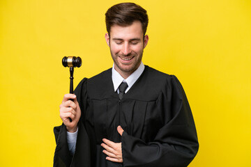 Wall Mural - Judge caucasian man isolated on yellow background smiling a lot