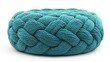© Bushra - A vibrant, oversized teal blue pouf with a thick, braided rope design, isolated on a white background. The pouf's large, round shape and intricate weaving pattern give it a rustic yet modern appeal.