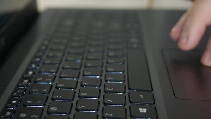 Blurred Shooting with a Businessman Using the Laptop Touchpad. Man Using a Notebook, Reading Emails and Browsing Internet Pages.